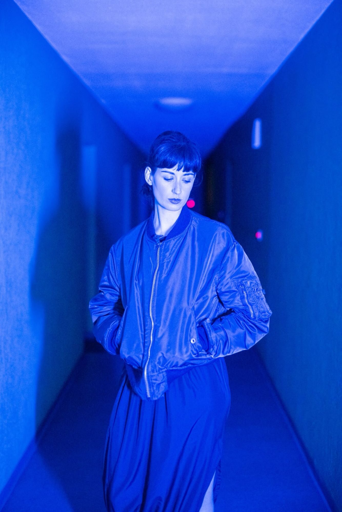 Maya Shenfeld in a blue corridor