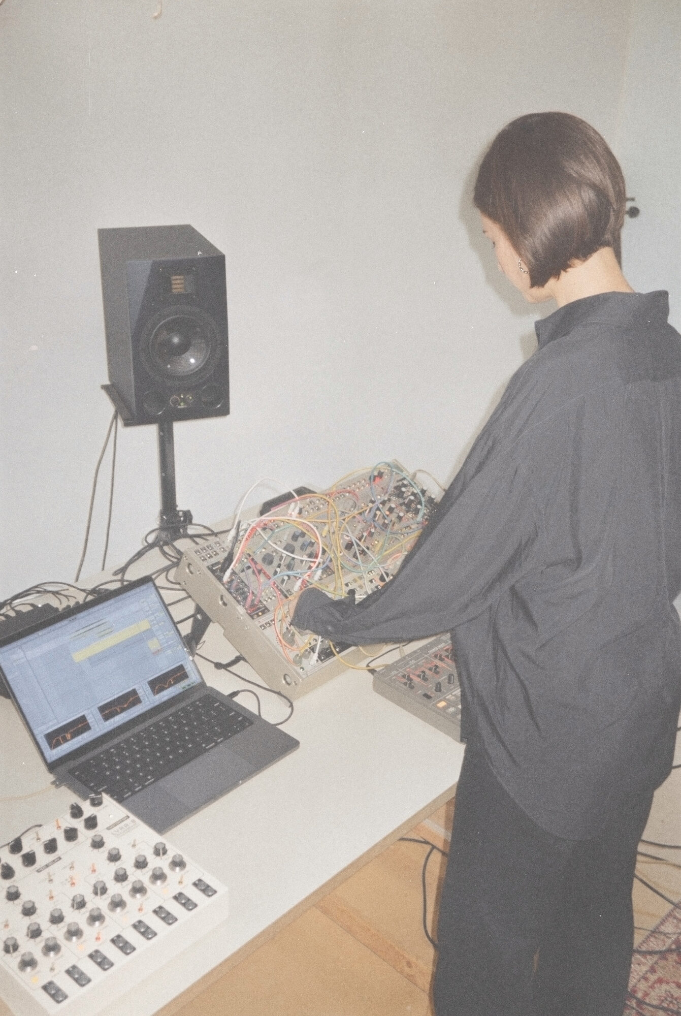 Maya Shenfeld at the speaker and modular synthesizer, from behind